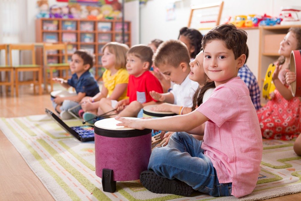 Children in class while holding instruments