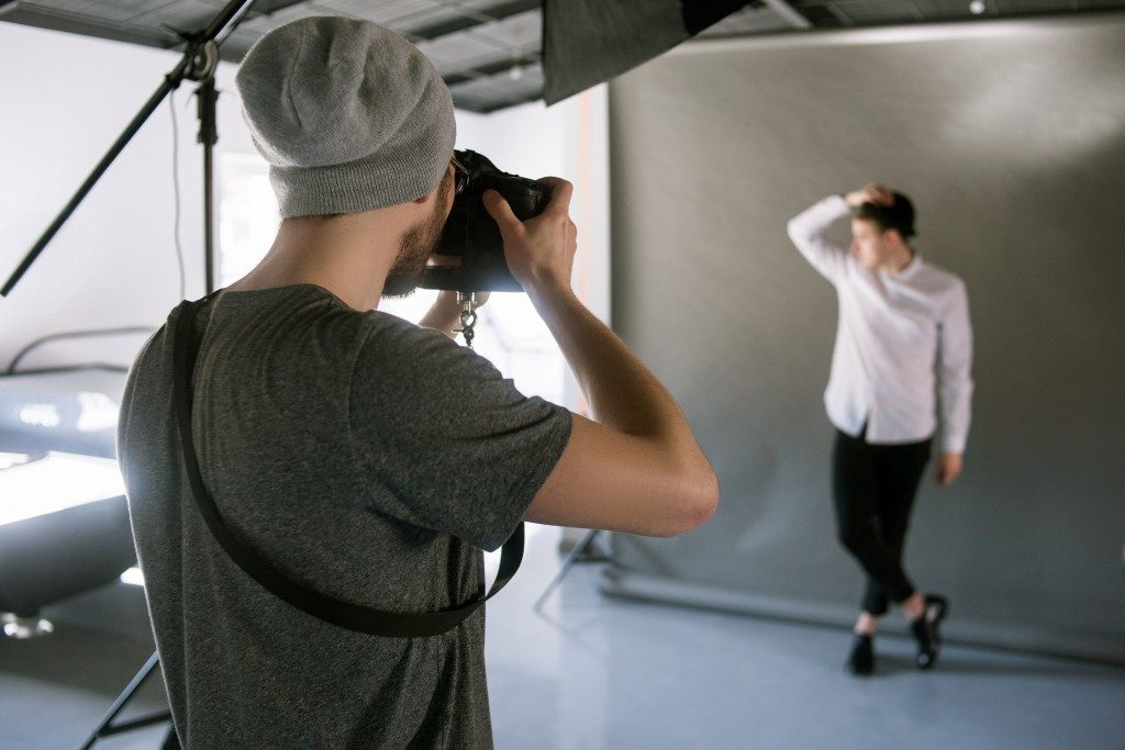 photographer taking photo of the model in the studio