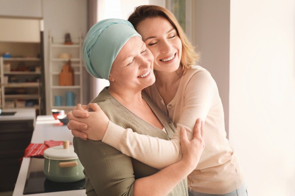 Woman with cancer hugging her daughter