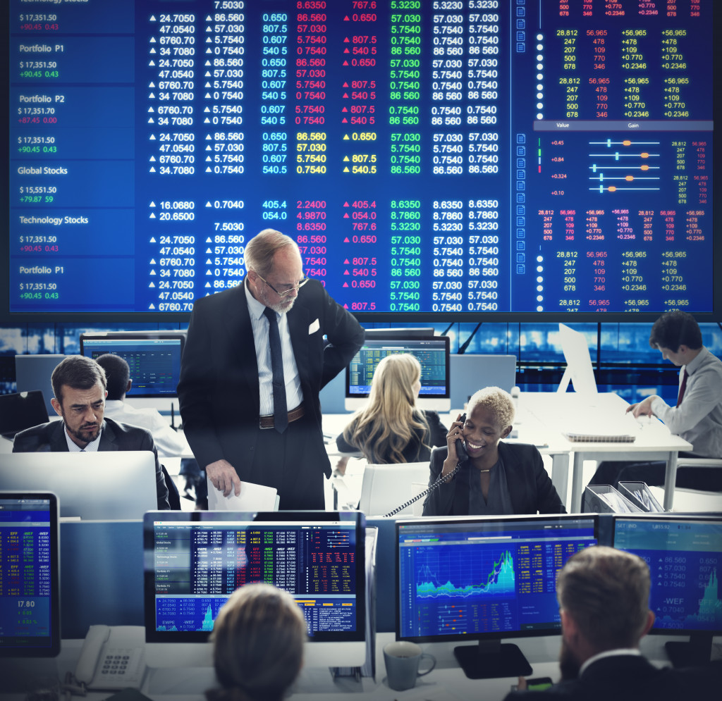stock market displayed on a big screen