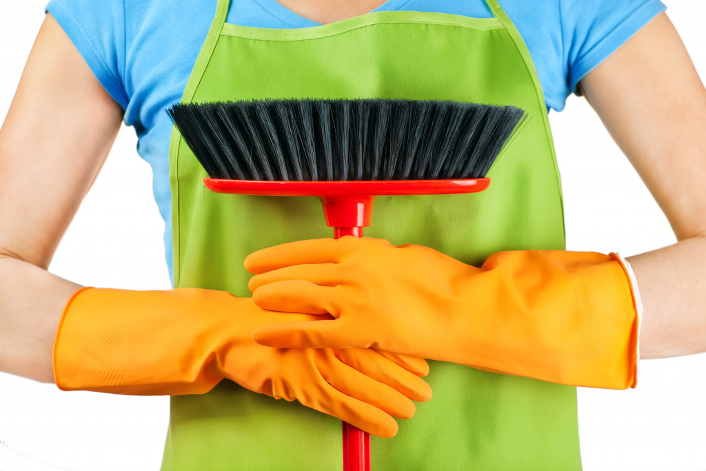 a person holding cleaning materials