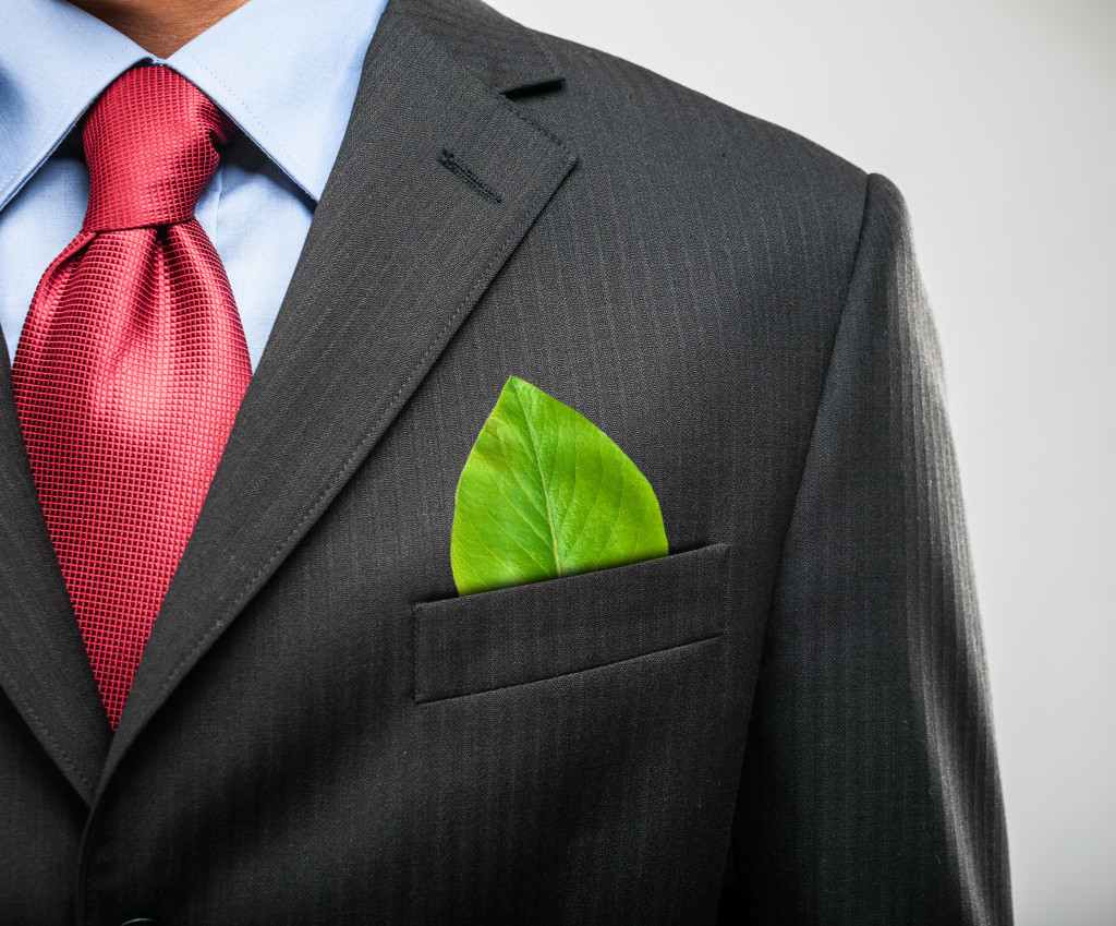 green leaf on businessman's pocket concept of sustainability